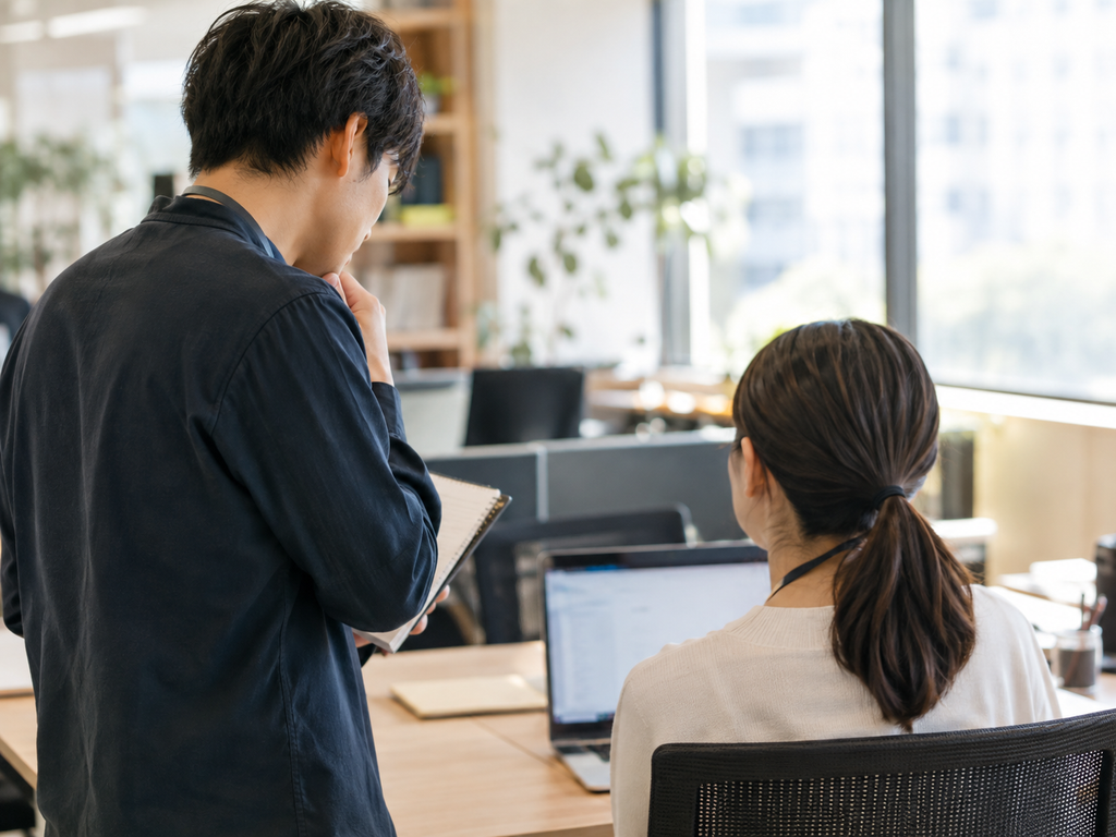 若い女性後輩に説明する男性先輩